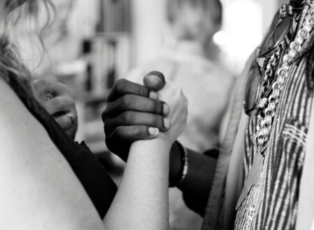 grayscale photo of man and woman holding their hands