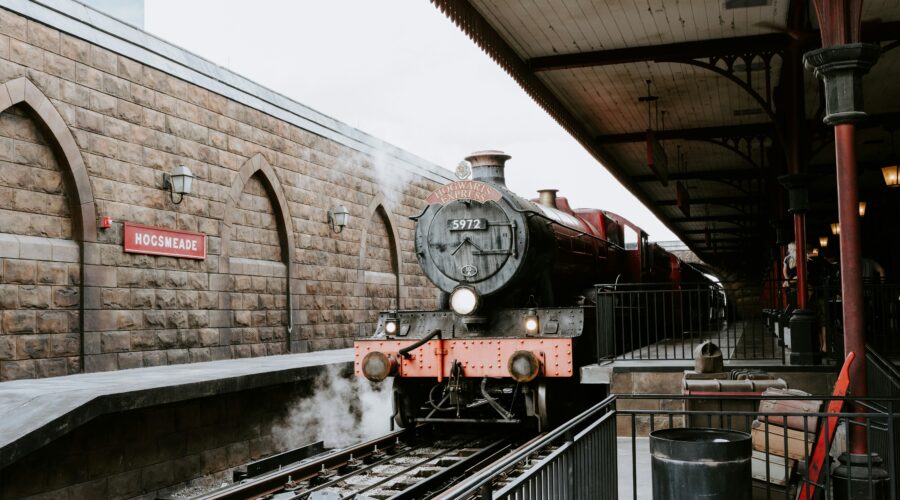 red and black train on rail tracks during daytime