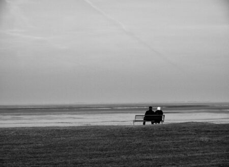 silhouette of two person sitting on bench