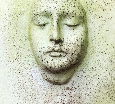 white human face carved on white wall