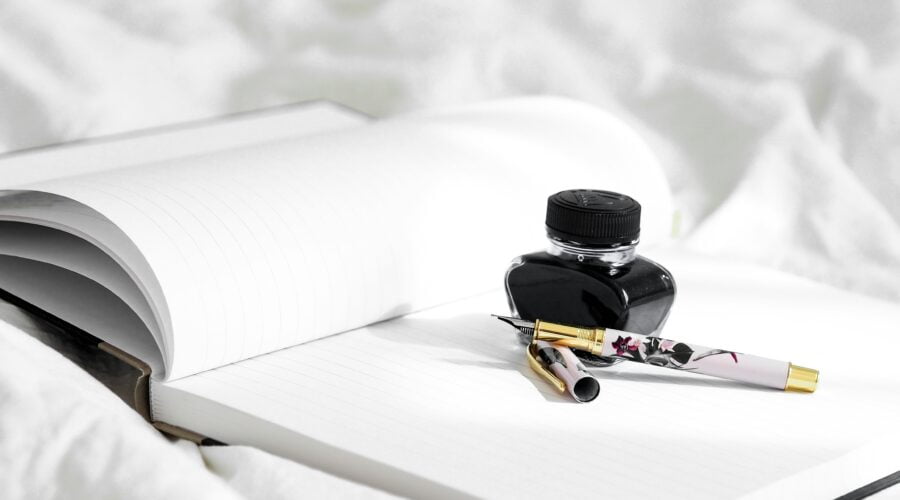 black and yellow bottle on white textile