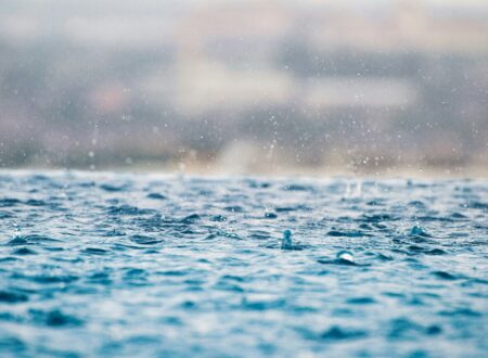 closeup photography of water drops on body of water