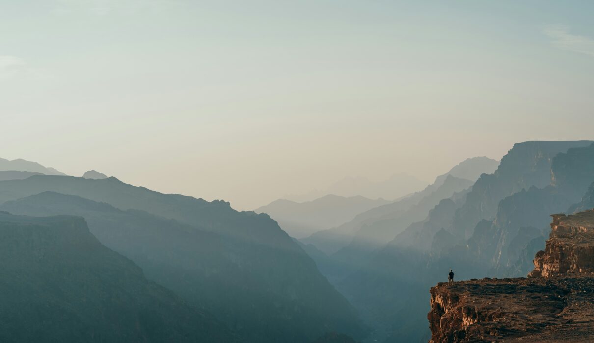 a person standing on top of a cliff