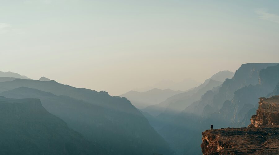 a person standing on top of a cliff