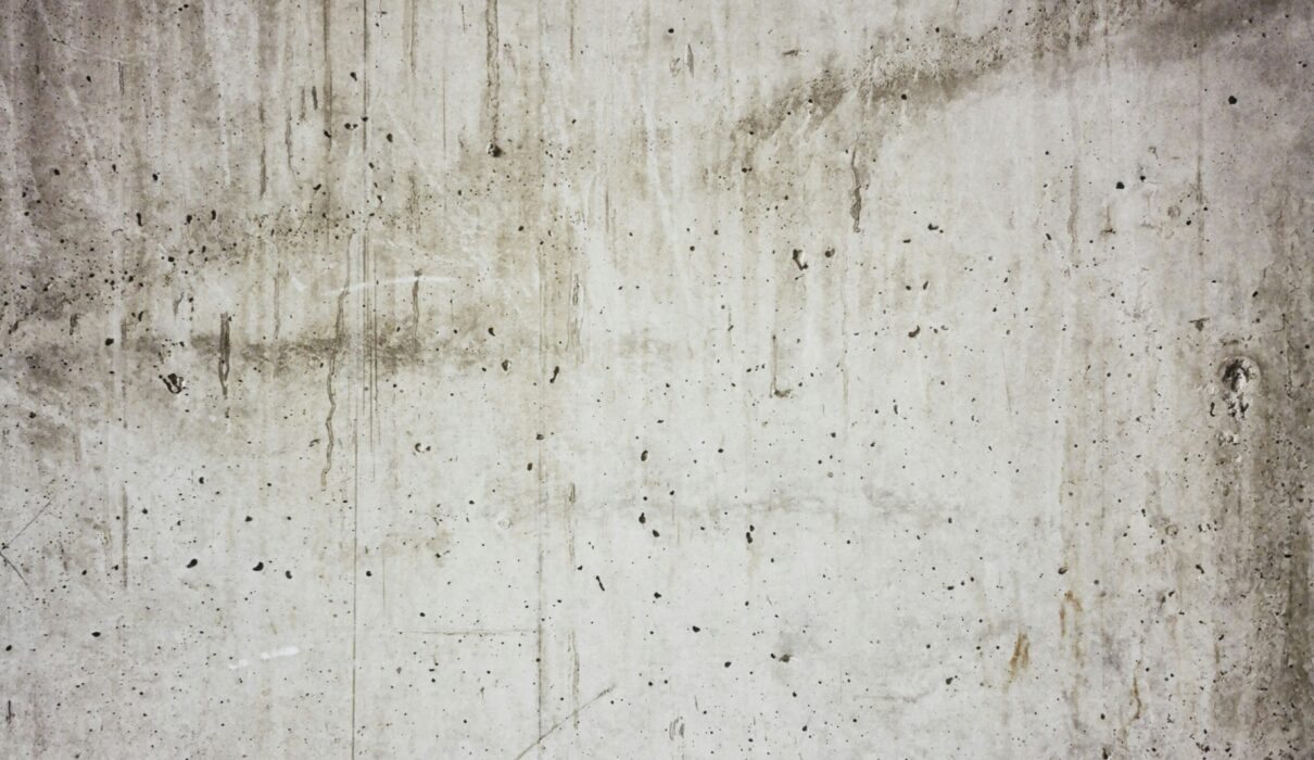 a white wall with some black dots on it