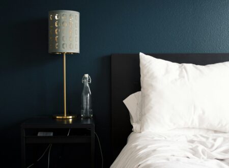 gray table lamp beside white bed pillow