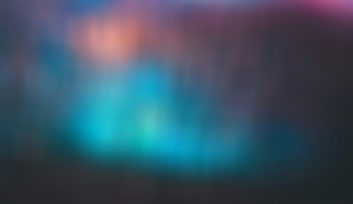 a blurry image of a blue and pink background